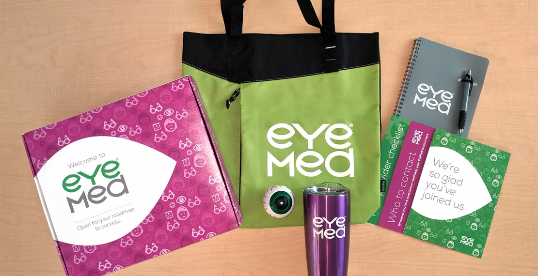 Welcome kit created for new EyeMed Vision Care providers including bag, notepad and pen, a stress ball that looks like an eye, travel tumbler, helpful brochures and the box all pieces are mailed in. 