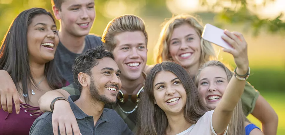 Photo of college students taking a group selfie.