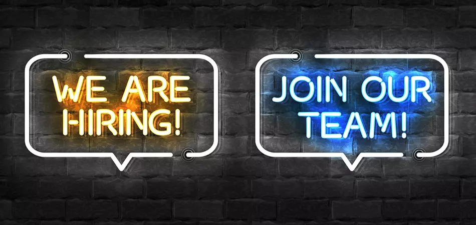 Neon signs that read, "we are hiring!" and "join our team!"